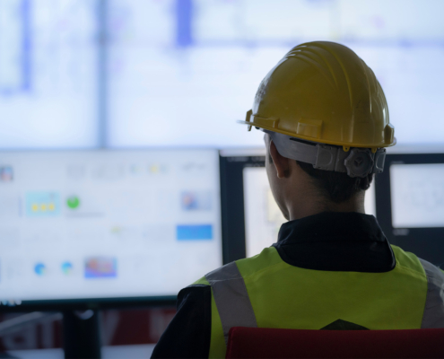 Industrial Engineering works in front of monitoring screen in the production control center